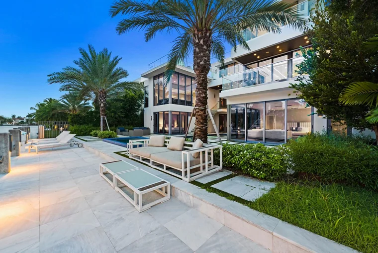 Waterfront estate terrace at dusk